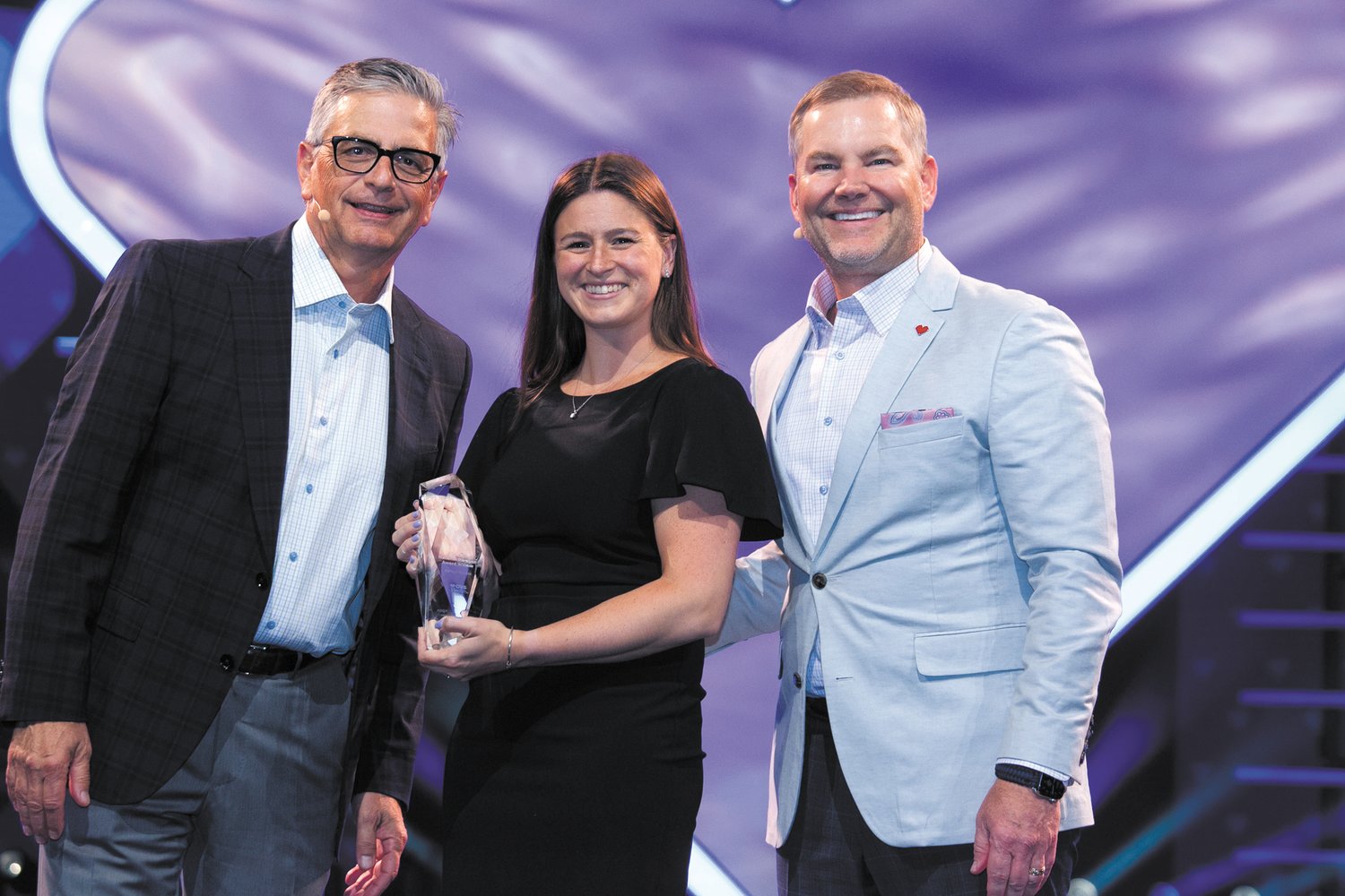 WELL-DESERVED RECOGNITION: Katie Pouliot, pharmacy manager for CVS on Reservoir Avenue, was recently recognized for her efforts and was awarded a 2022 Paragon Award for business leadership and customer service from CVS Health on Aug. 3. Here she is with Senior Vice President of field operations Brian Bosnic (left) and Senior Vice President of field operations Jeff Schmidt.